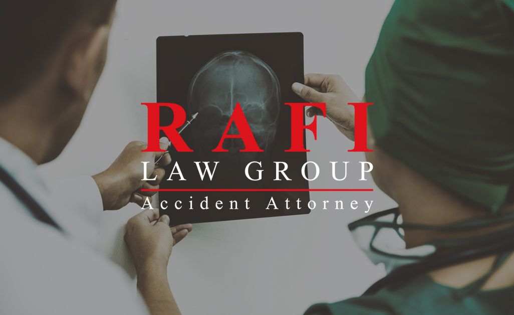 White male doctor and white female nurse look at brain and skull image