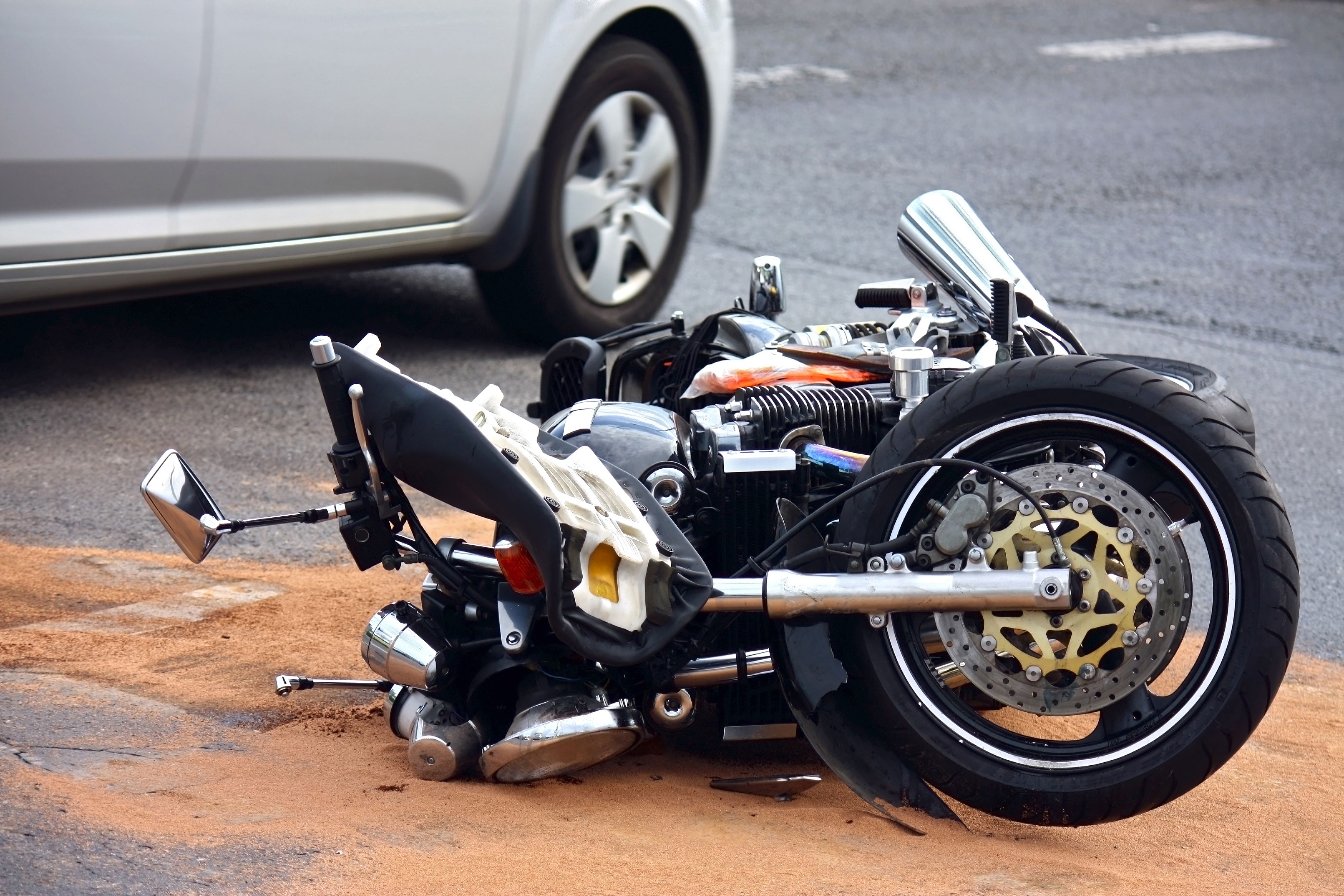 Motorcycle laying on the road after an accident